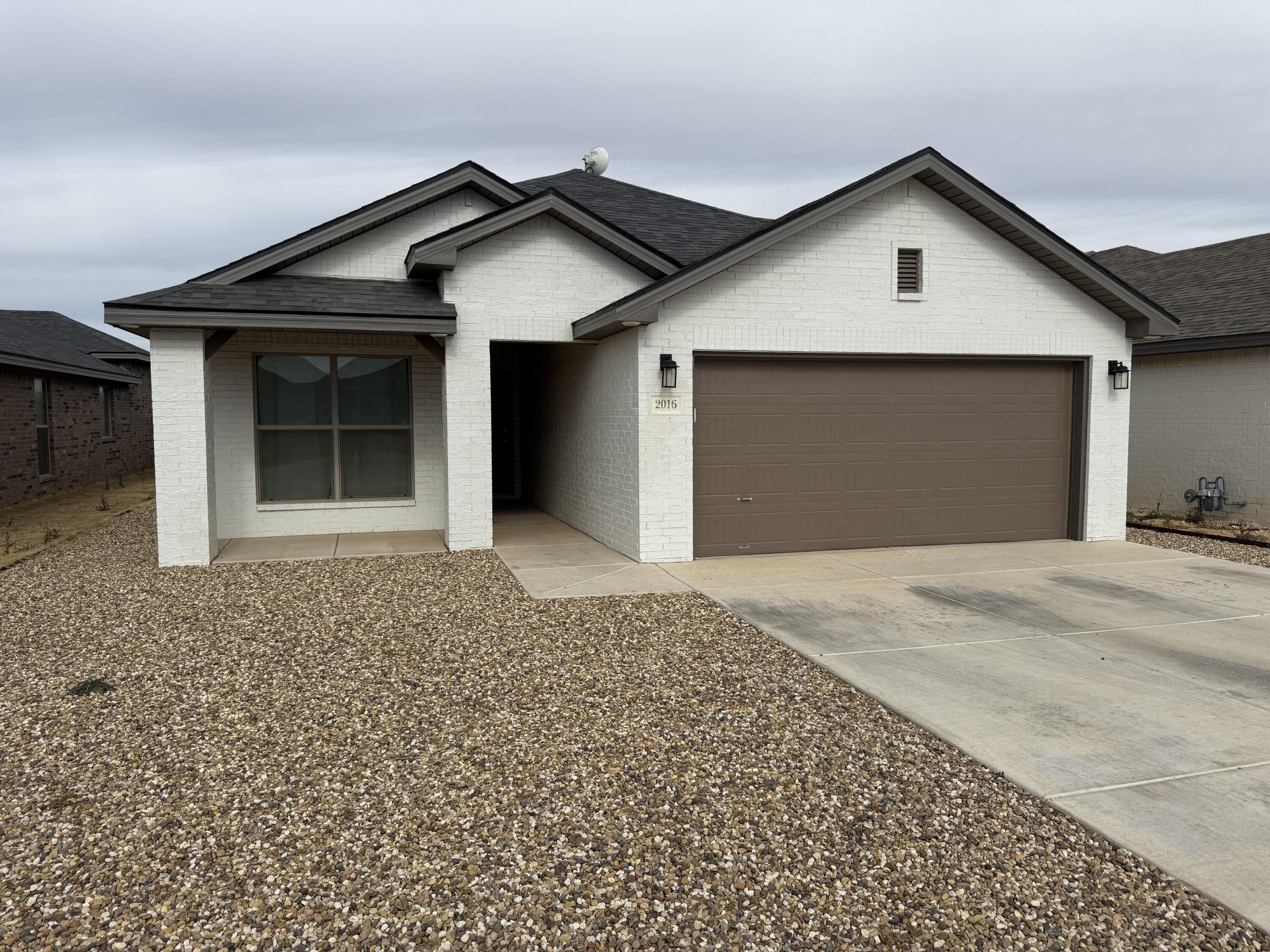 2016 132nd Street Lubbock, TX 79423 - Photo 28 of 28 a front view of a house with a yard and garage