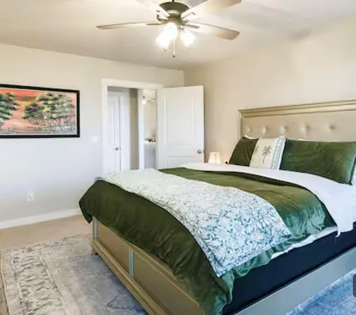 a bedroom with a bed and a ceiling fan