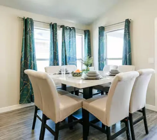 a view of a dining room with furniture window and wooden floor