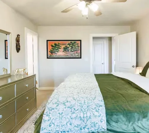 a bedroom with a bed and a dresser