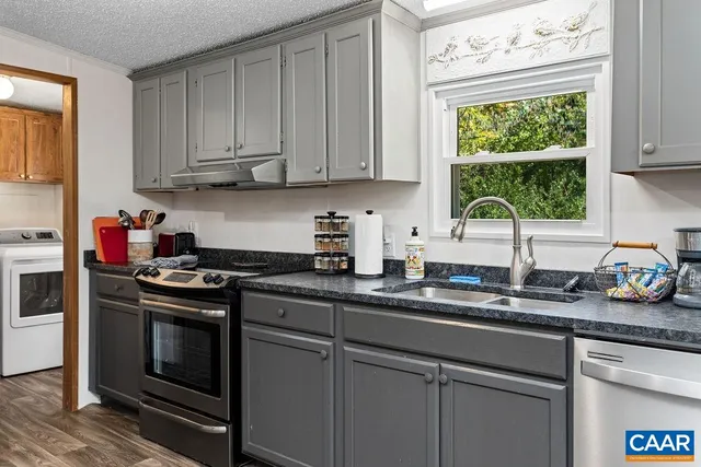 a kitchen with appliances cabinets and a window