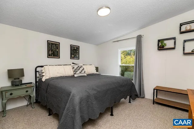 a bedroom with a bed and a desk