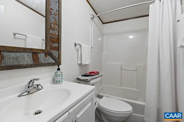 a bathroom with a sink toilet vanity and shower