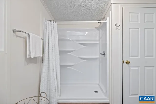 a bathroom with a glass shower door