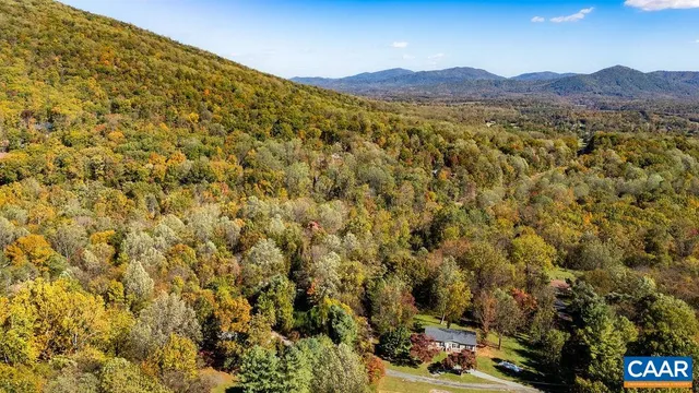 an aerial view of a house with a yard and garden