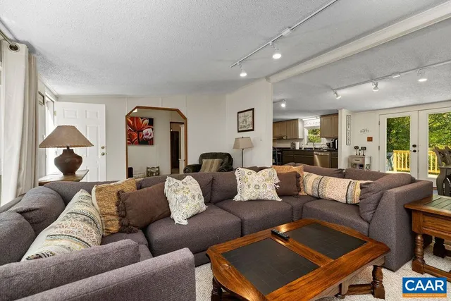 a living room with furniture and a lamp