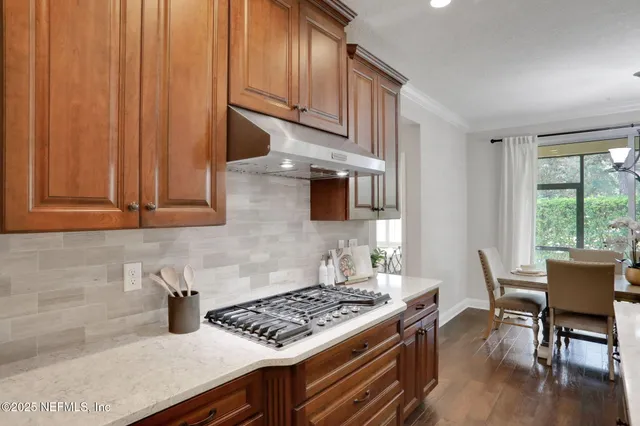 an aerial view of a house with a yard and lake view