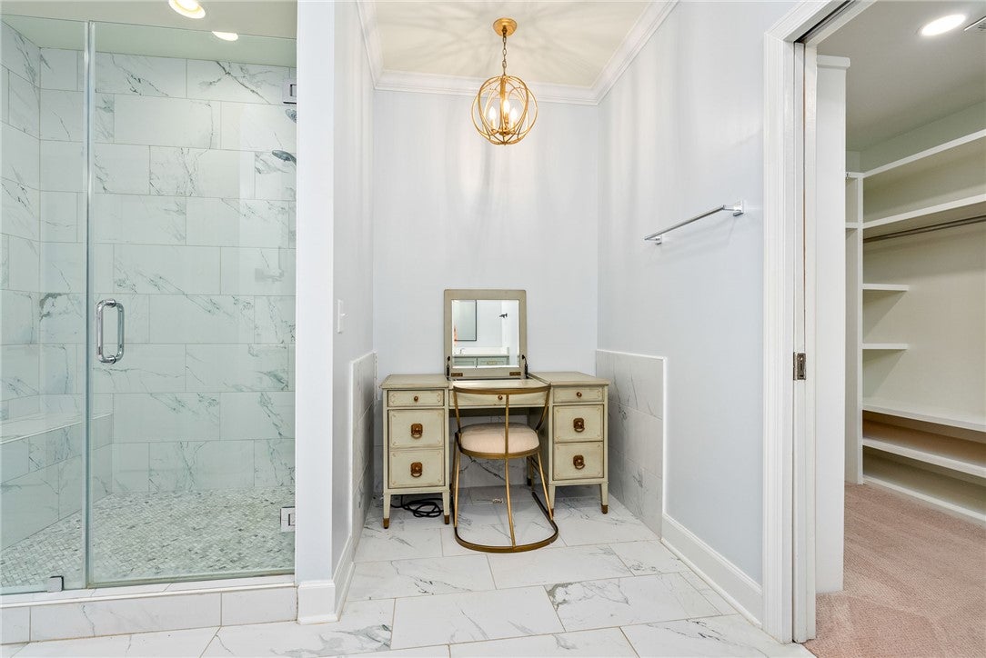 1657 Abby Road Auburn, AL 36830 - Photo 19 of 39 This serene primary bathroom offers a spacious walk-in shower and elegant tile flooring.