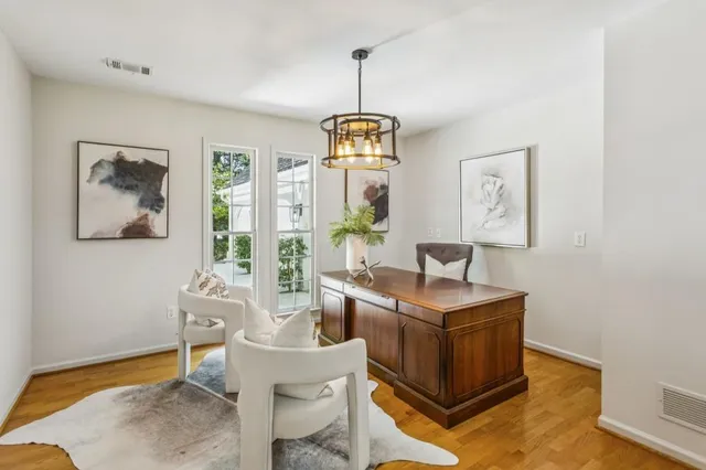 a spacious bedroom with a bed a couch and large window