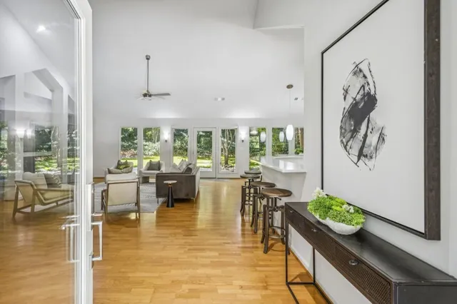 a living room with fireplace furniture and a large window