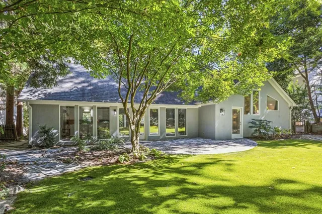 a house view with swimming pool in front of it