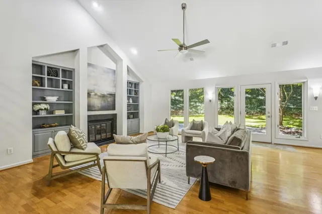 a living room with furniture and a floor to ceiling window