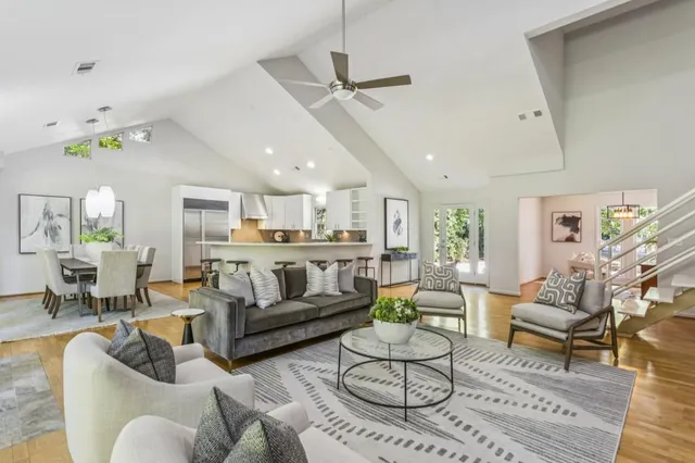 a living room with furniture and a view of kitchen