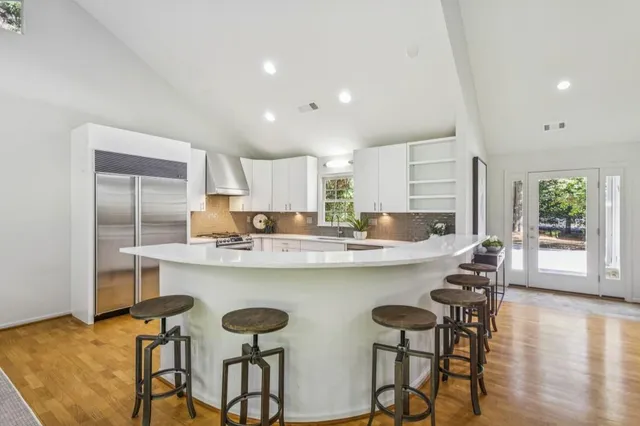 a kitchen with cabinets and chairs
