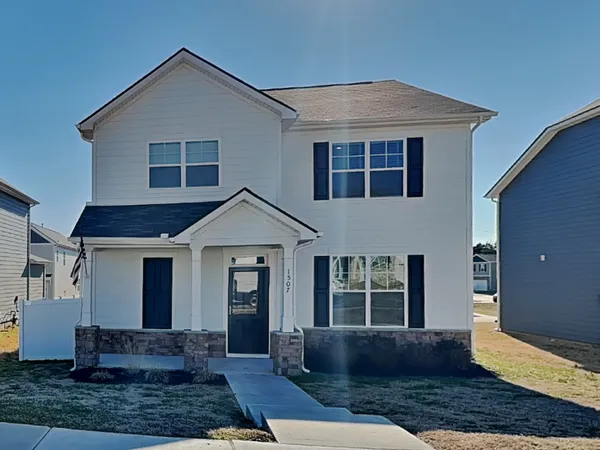 a front view of a house with a yard