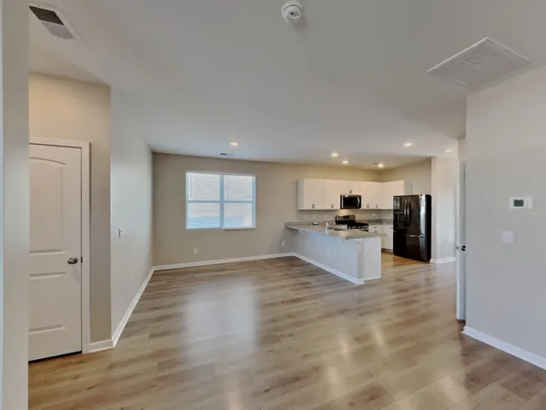 a view of kitchen with refrigerator and window