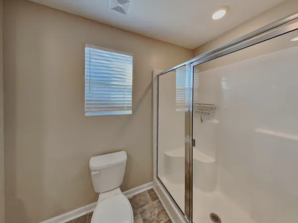 a bathroom with a toilet sink and shower