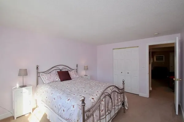 a bedroom with a bed and a night stand