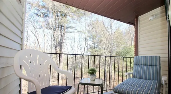 a view of a balcony with furniture