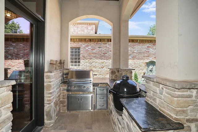 a view of a patio with couches chairs and a potted plant