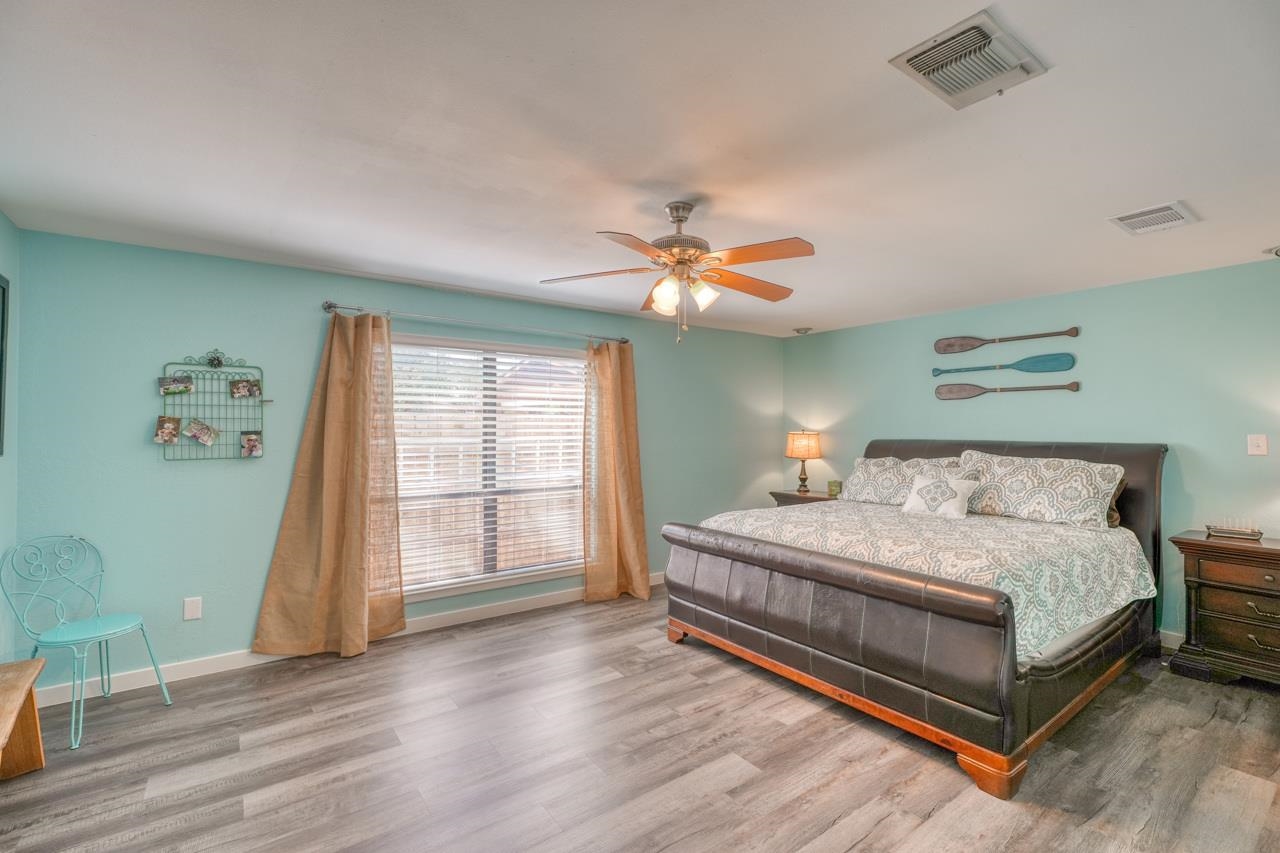724 South Chaparral Burnet, TX 78611 - Photo 11 of 29 a bedroom with a bed and a chandelier