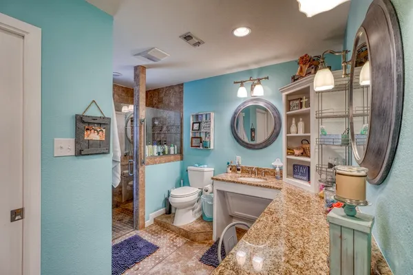 a bedroom with a bed ceiling fan and a window
