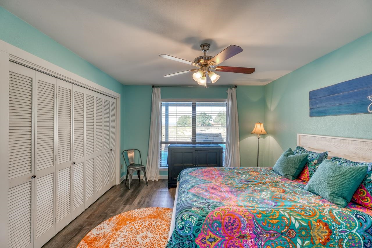 724 South Chaparral Burnet, TX 78611 - Photo 13 of 29 a bedroom with a bed ceiling fan and a window