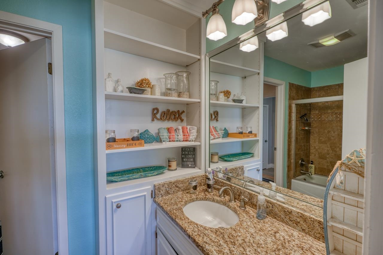 724 South Chaparral Burnet, TX 78611 - Photo 14 of 29 a bathroom with a sink a vanity and a mirror