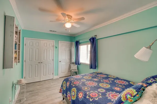 a bedroom with a bunk bed and a chandelier