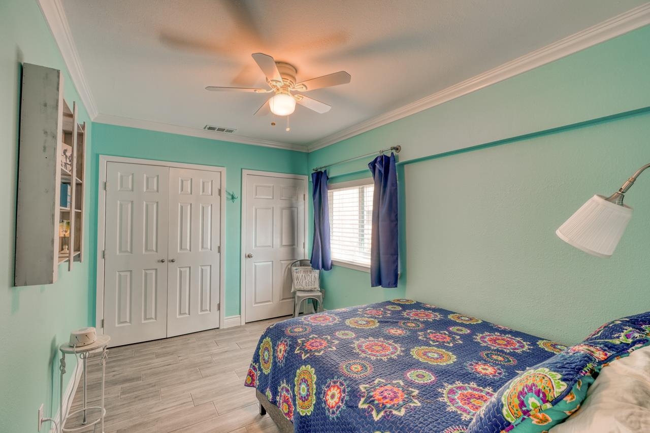 724 South Chaparral Burnet, TX 78611 - Photo 17 of 29 a bedroom with a bed and a chandelier