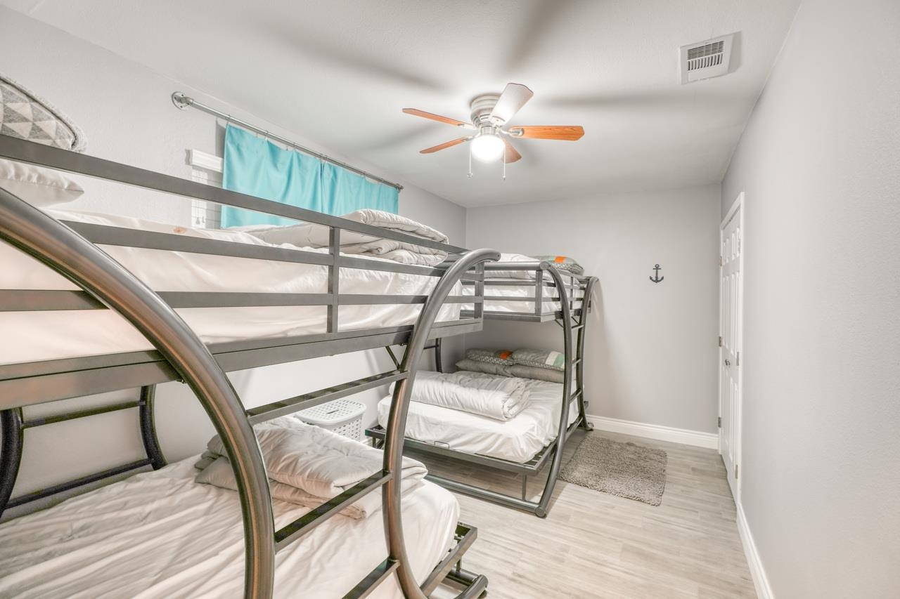 724 South Chaparral Burnet, TX 78611 - Photo 18 of 29 a bedroom with a bunk bed and a chandelier