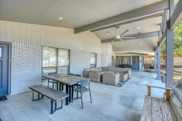 a dining room with furniture and a floor to ceiling window