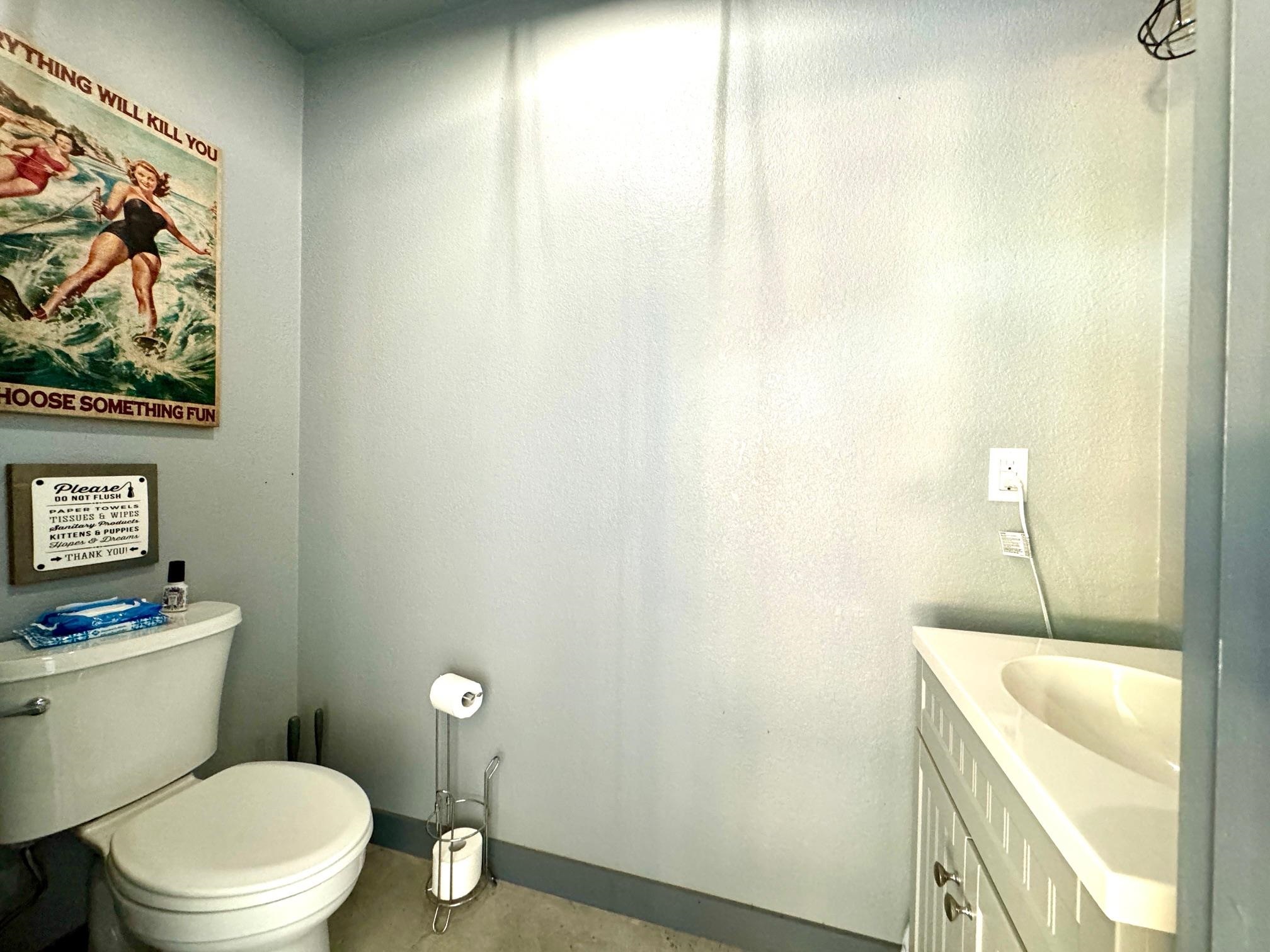 724 South Chaparral Burnet, TX 78611 - Photo 24 of 29 a bathroom with a granite countertop toilet and a sink