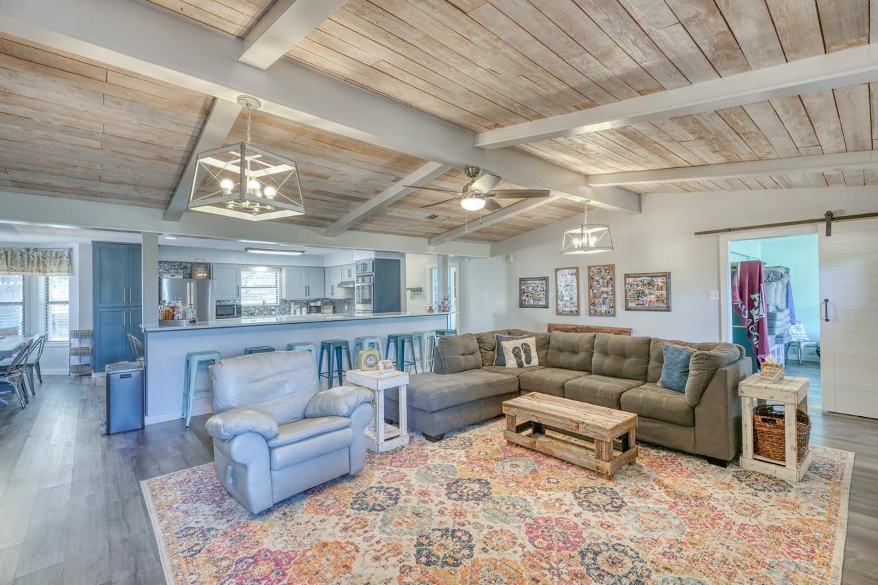 724 South Chaparral Burnet, TX 78611 - Photo 5 of 29 a living room with furniture and a chandelier