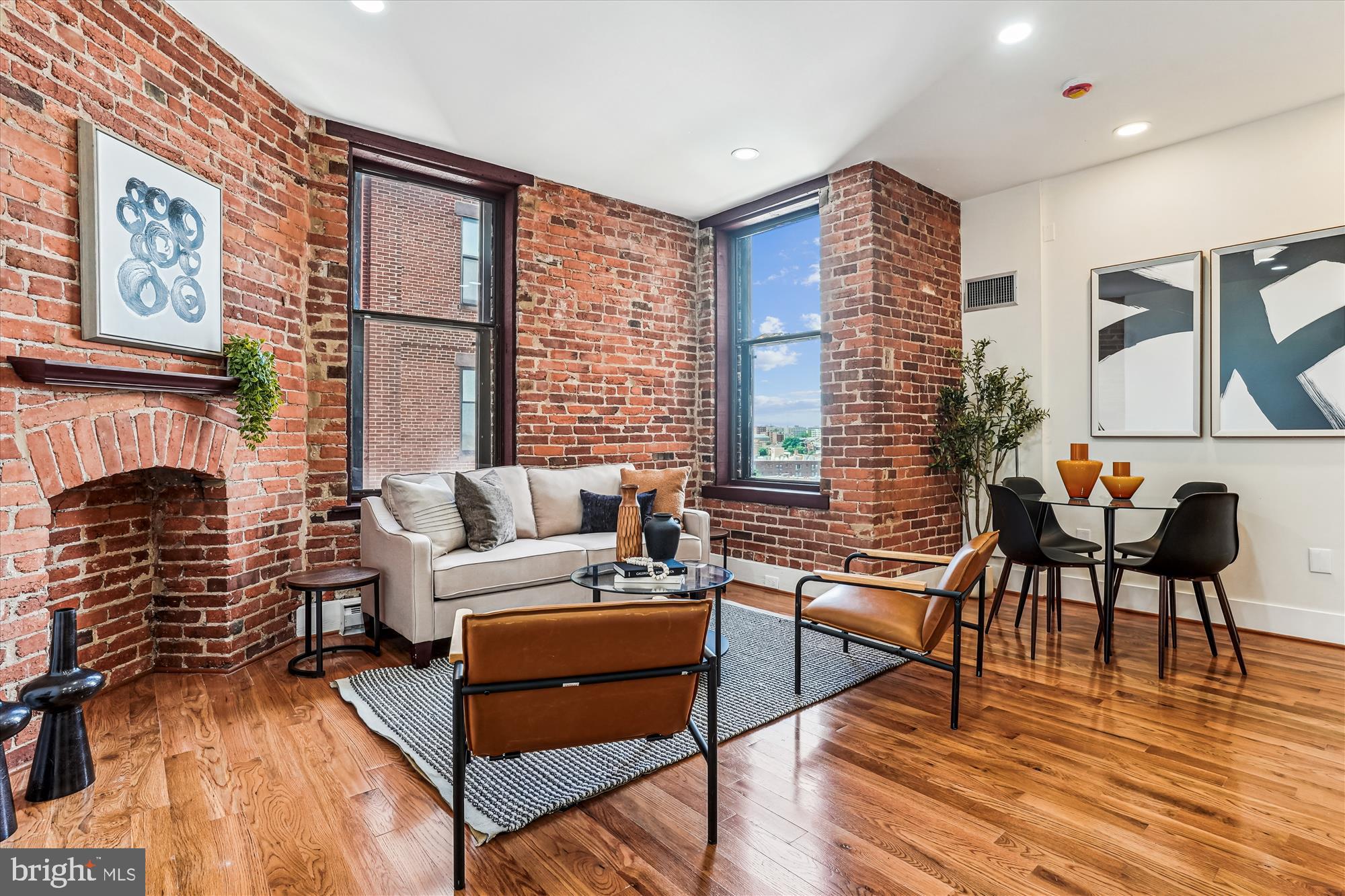 1615 Q Street Northwest, Unit 1012 Washington, DC 20009 - Photo 1 of 39 a living room with fireplace furniture and a large window
