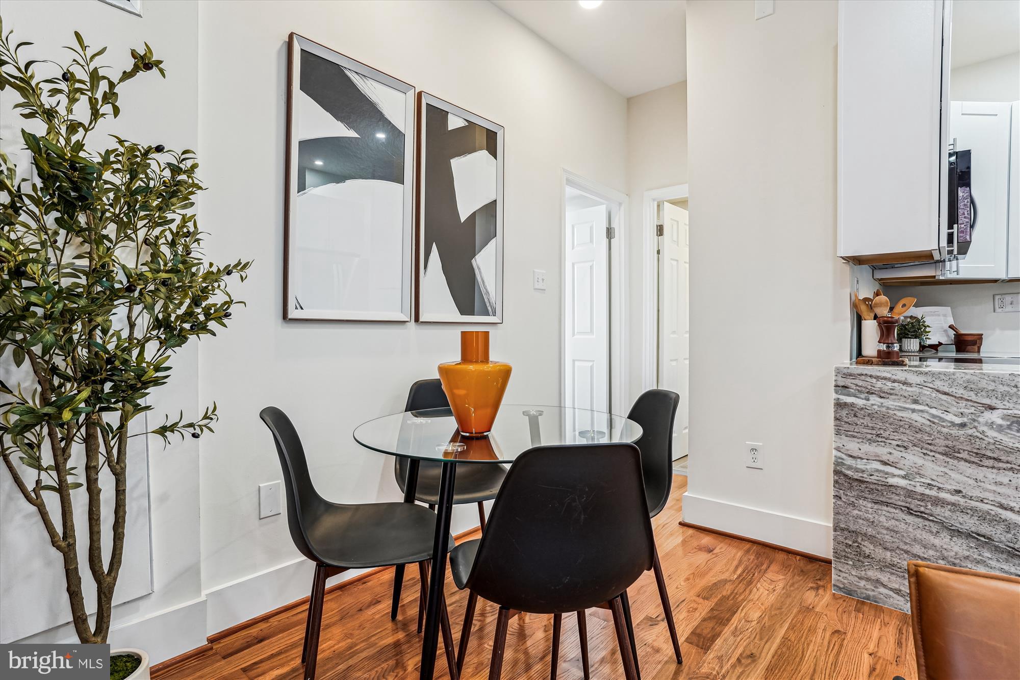 1615 Q Street Northwest, Unit 1012 Washington, DC 20009 - Photo 11 of 39 a dining room with furniture and wooden floor