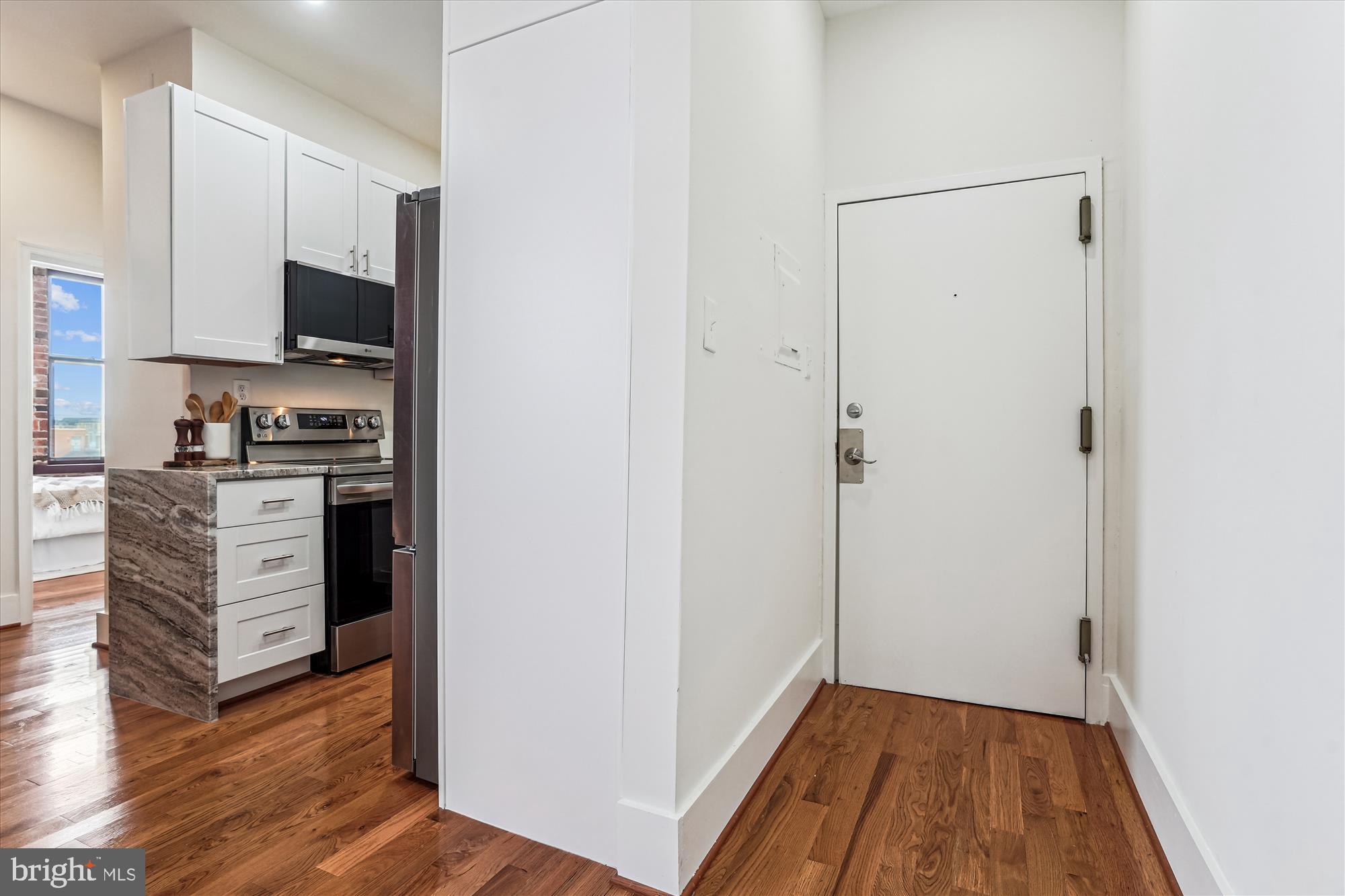 1615 Q Street Northwest, Unit 1012 Washington, DC 20009 - Photo 13 of 39 a view of kitchen with wooden floor and electronic appliances