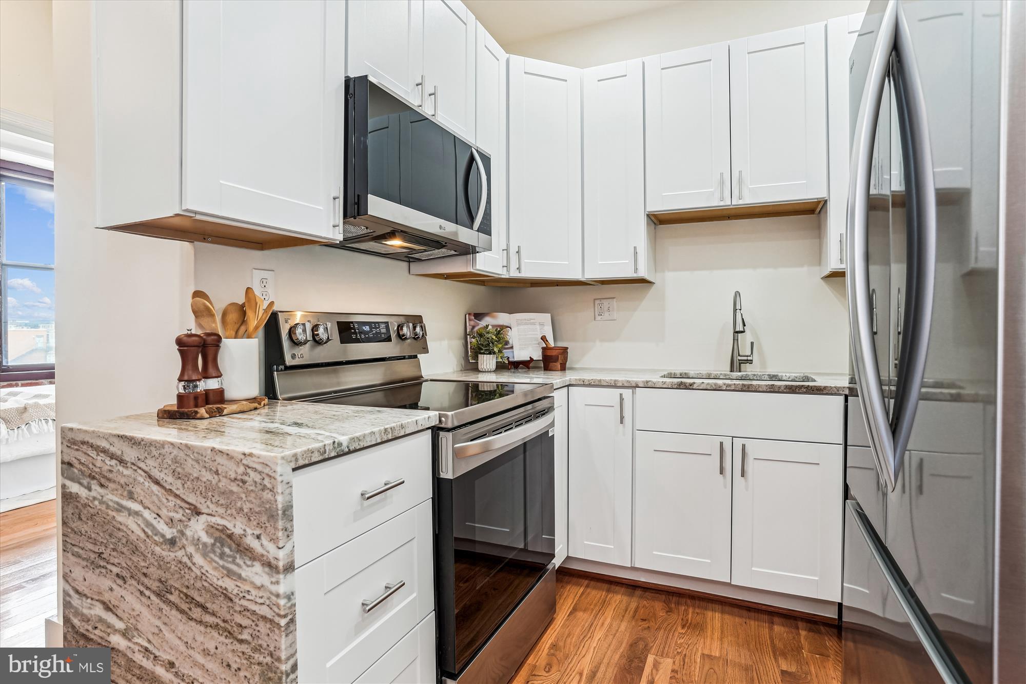 1615 Q Street Northwest, Unit 1012 Washington, DC 20009 - Photo 14 of 39 a kitchen with stainless steel appliances granite countertop a sink stove and refrigerator
