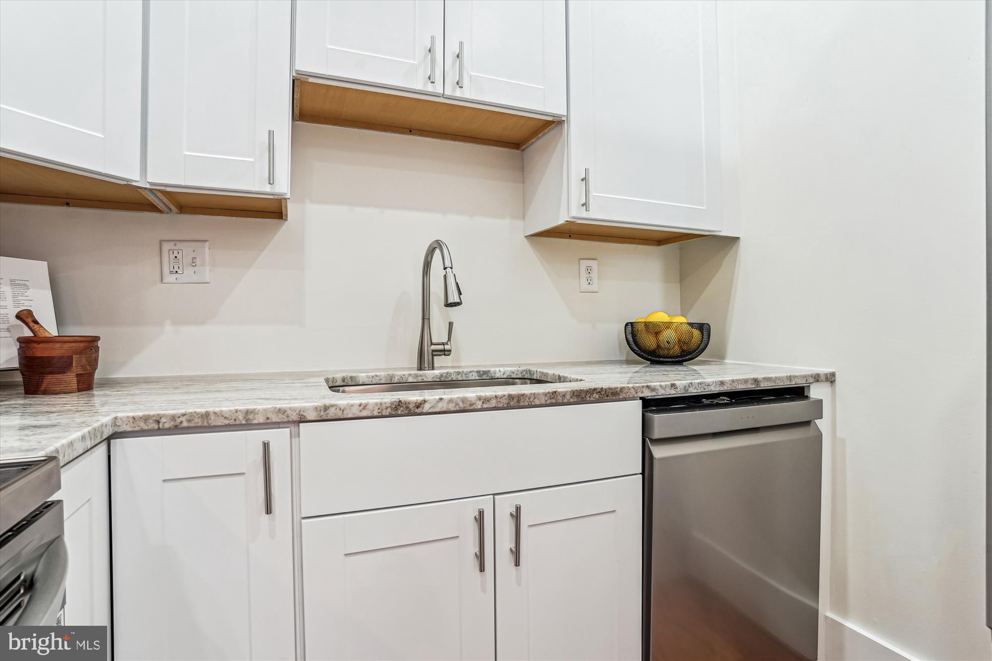 1615 Q Street Northwest, Unit 1012 Washington, DC 20009 - Photo 15 of 39 a kitchen with a sink a stove and cabinets
