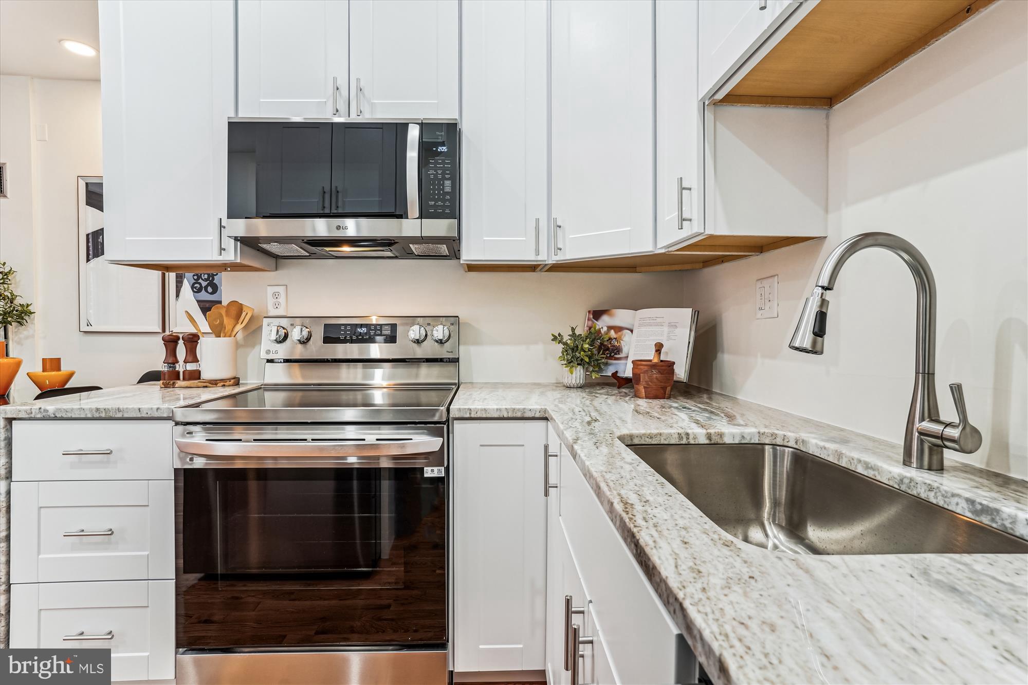 1615 Q Street Northwest, Unit 1012 Washington, DC 20009 - Photo 16 of 39 a kitchen with stainless steel appliances granite countertop a stove and a sink