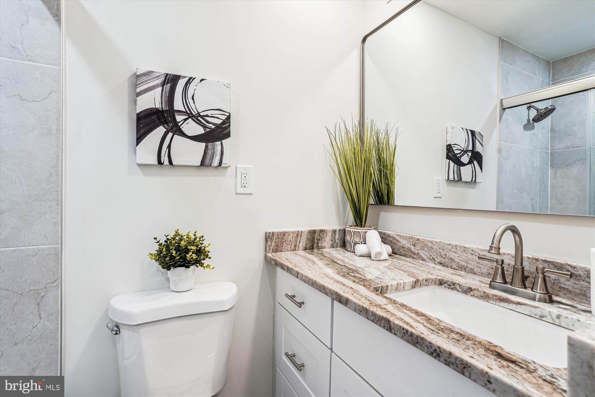 1615 Q Street Northwest, Unit 1012 Washington, DC 20009 - Photo 23 of 39 a bathroom with a toilet sink and mirror