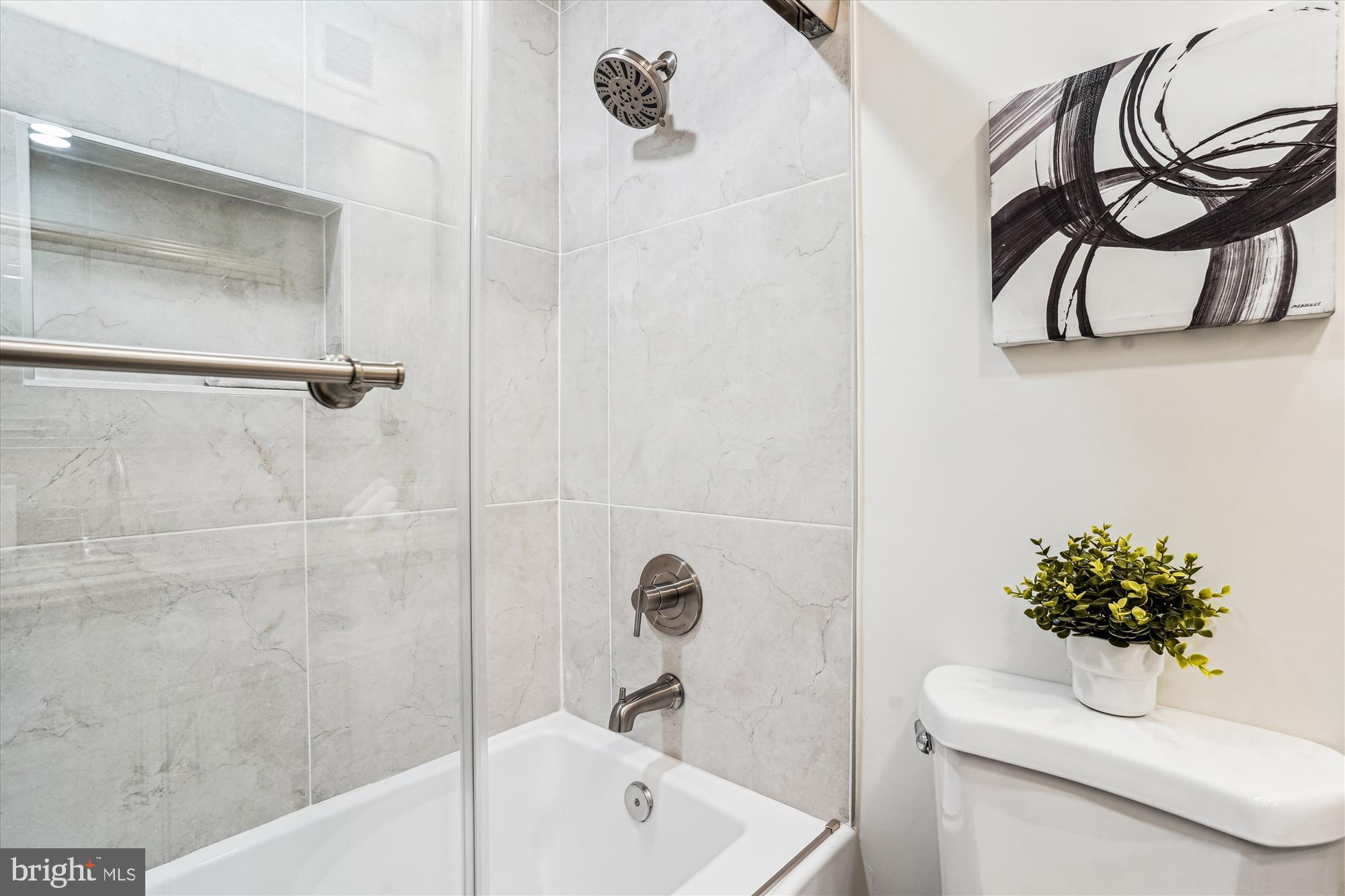 1615 Q Street Northwest, Unit 1012 Washington, DC 20009 - Photo 24 of 39 a bathroom with a sink a toilet and shower