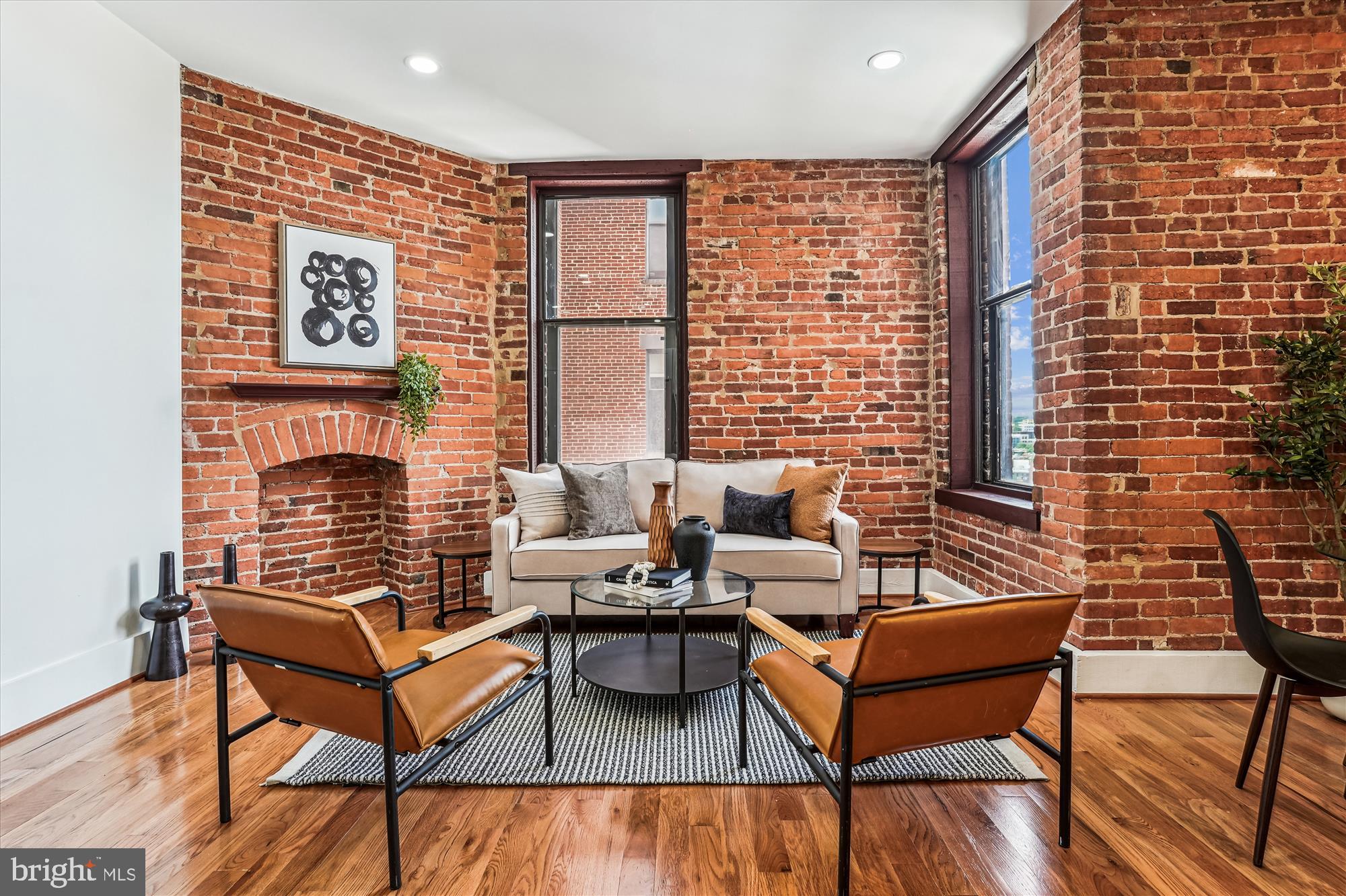 1615 Q Street Northwest, Unit 1012 Washington, DC 20009 - Photo 5 of 39 a living room with furniture and a fireplace