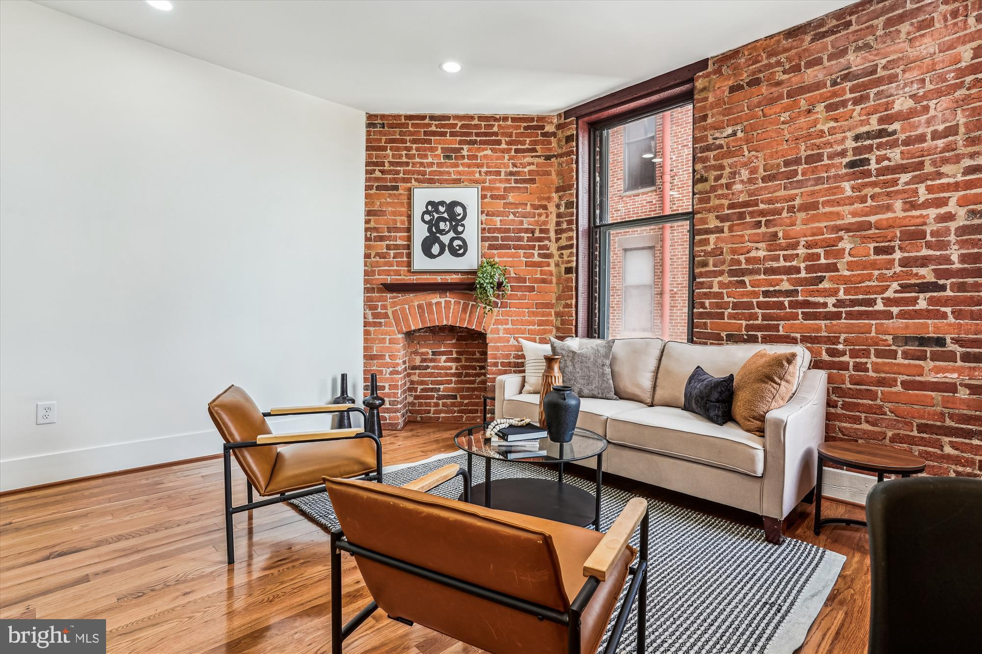 1615 Q Street Northwest, Unit 1012 Washington, DC 20009 - Photo 6 of 39 a living room with furniture and a fireplace