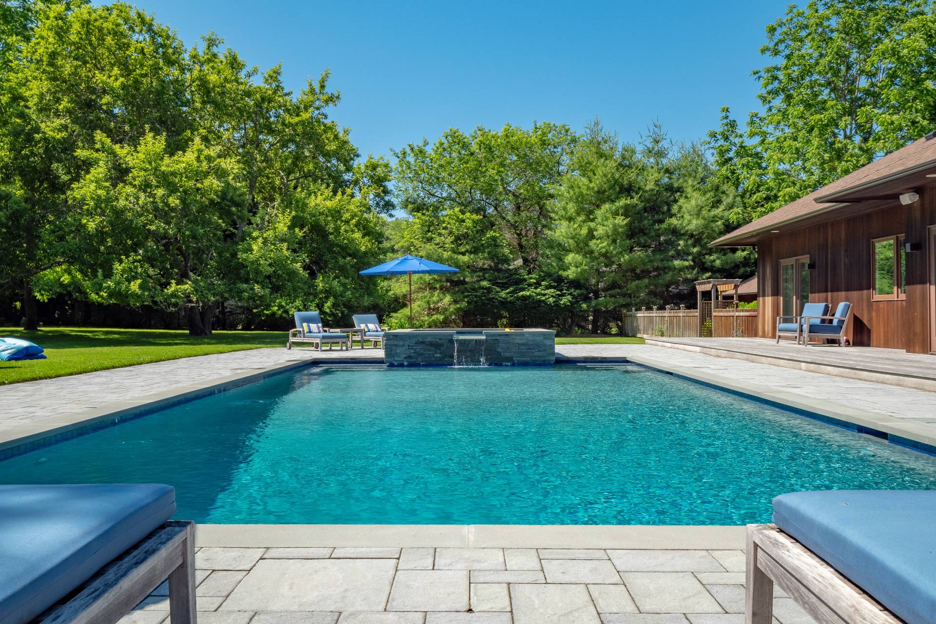 6 Bridle Path Remsenburg, NY 11960 - Photo 15 of 15 a view of a swimming pool with a table and chairs
