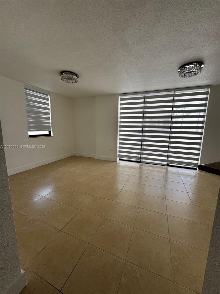 2301 Southwest 27th Avenue, Unit 503 Miami, FL 33145 - Photo 3 of 24 a view of a livingroom with an empty space and a window