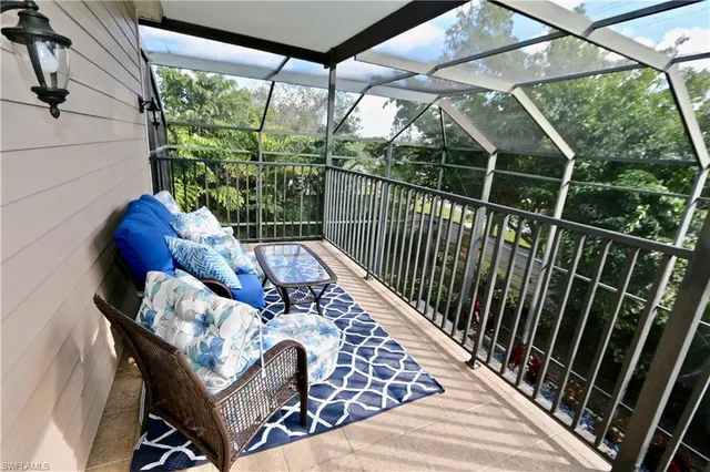 a view of a balcony with chairs and potted plants