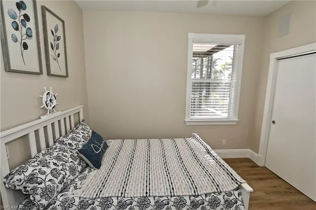 a kitchen with a wooden floor and a window