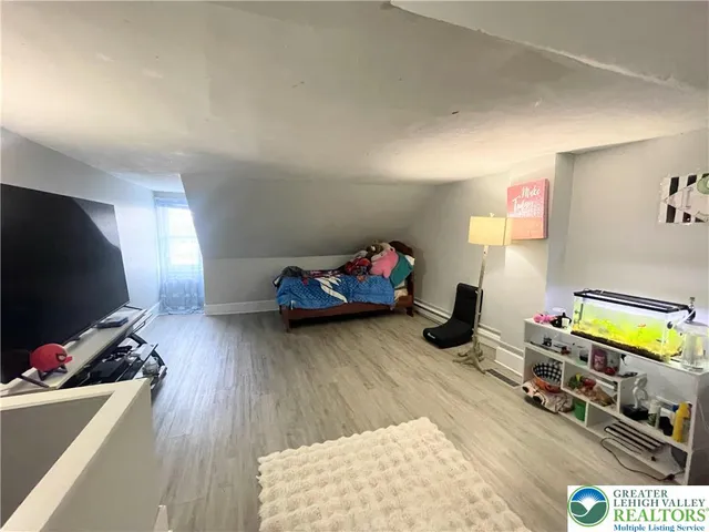 a bedroom with furniture and a flat screen tv