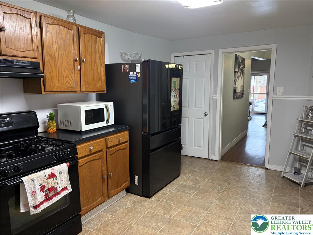 633 Maple Street Bethlehem, PA 18018 - Photo 7 of 14 a kitchen with stainless steel appliances granite countertop a refrigerator stove and sink